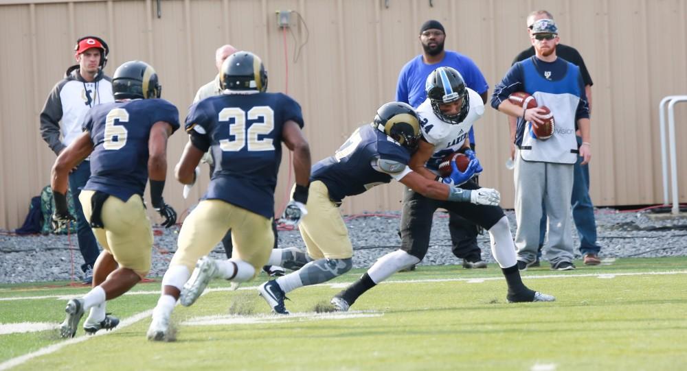 GVL / Kevin Sielaff - Matt Williams (24) receives the ball, but he is met by a hoard of Shepard defenders.  The Lakers fall to the Rams of Shepard University with a final score of 34-32 Dec. 12 in Shepardstown, West Virginia.