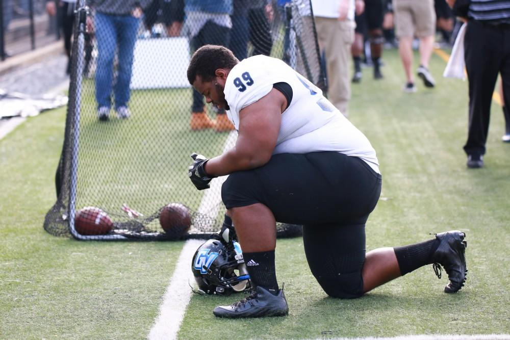 GVL / Kevin Sielaff - Sonny Haskins (99) takes a knee before the start of the match.  The Lakers fall to the Rams of Shepard University with a final score of 34-32 Dec. 12 in Shepardstown, West Virginia.