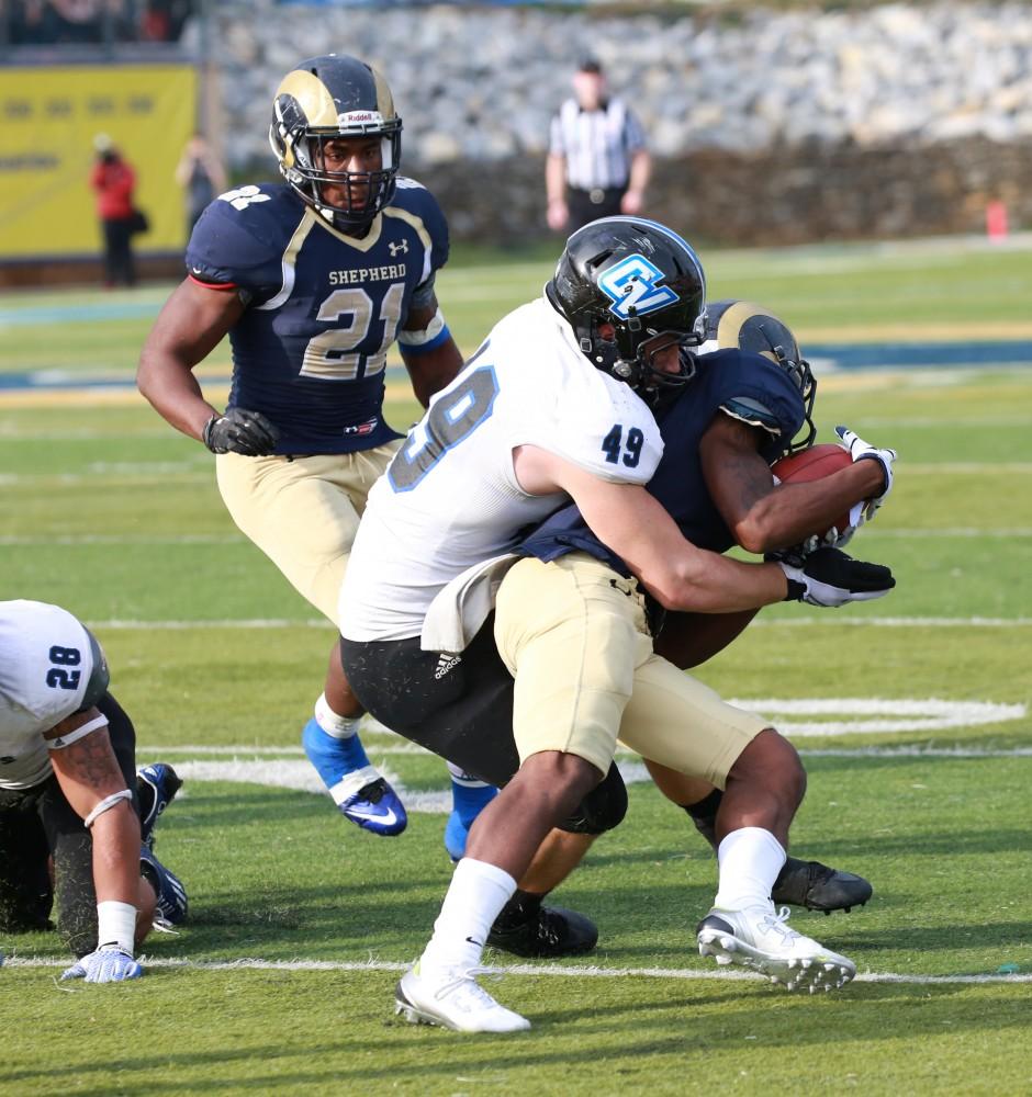 GVL / Kevin Sielaff - Collin Schlosser (49) brings down a Shepard running back.  The Lakers fall to the Rams of Shepard University with a final score of 34-32 Dec. 12 in Shepardstown, West Virginia.