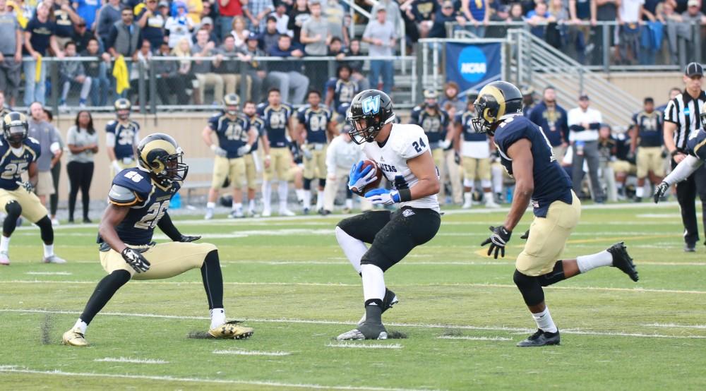 GVL / Kevin Sielaff - Bart Williams (24) receives the ball and is met by three Shepard defenders.  The Lakers fall to the Rams of Shepard University with a final score of 34-32 Dec. 12 in Shepardstown, West Virginia.