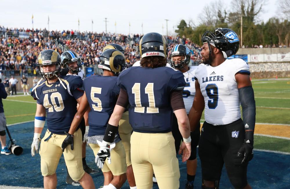 GVL / Kevin Sielaff - Grand Valley and Shepard meet at the center of the field for the coin toss.  The Lakers fall to the Rams of Shepard University with a final score of 34-32 Dec. 12 in Shepardstown, West Virginia.