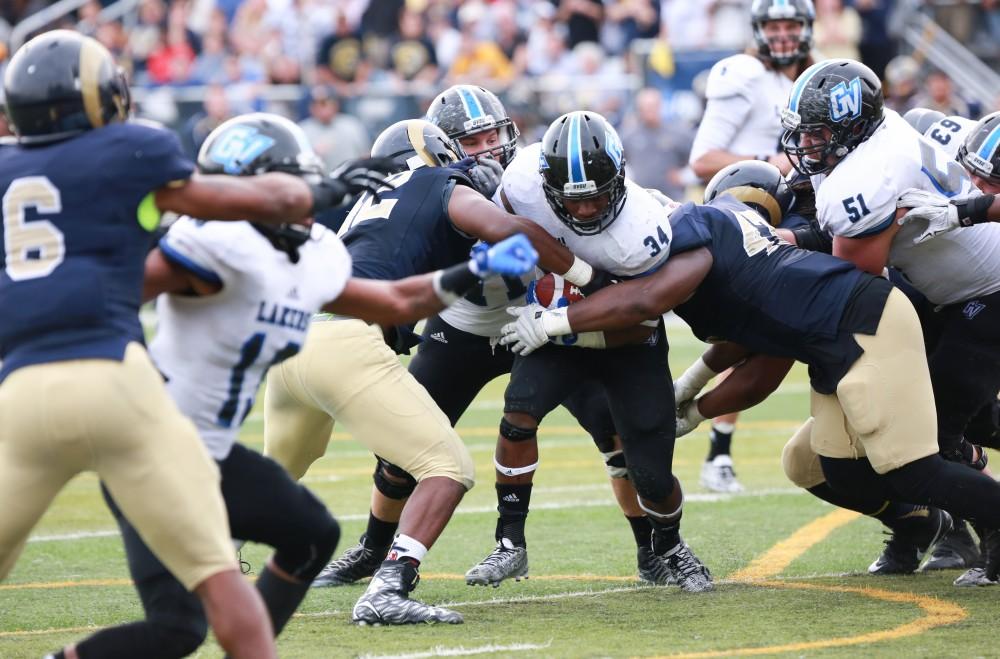 GVL / Kevin Sielaff - Marty Carter (34) pushes toward the end zone, but is stopped by a hoard of Shepard defensemen.  The Lakers fall to the Rams of Shepard University with a final score of 34-32 Dec. 12 in Shepardstown, West Virginia.