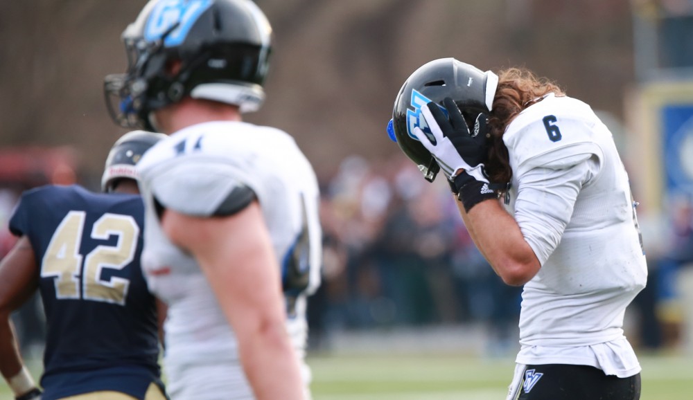 GVL / Kevin Sielaff - Bart Williams (6), after not having reached Matt Williams (24) on the final two point conversion play, returns to the Grand Valley bench.  The Lakers fall to the Rams of Shepard University with a final score of 34-32 Dec. 12 in Shepardstown, West Virginia.