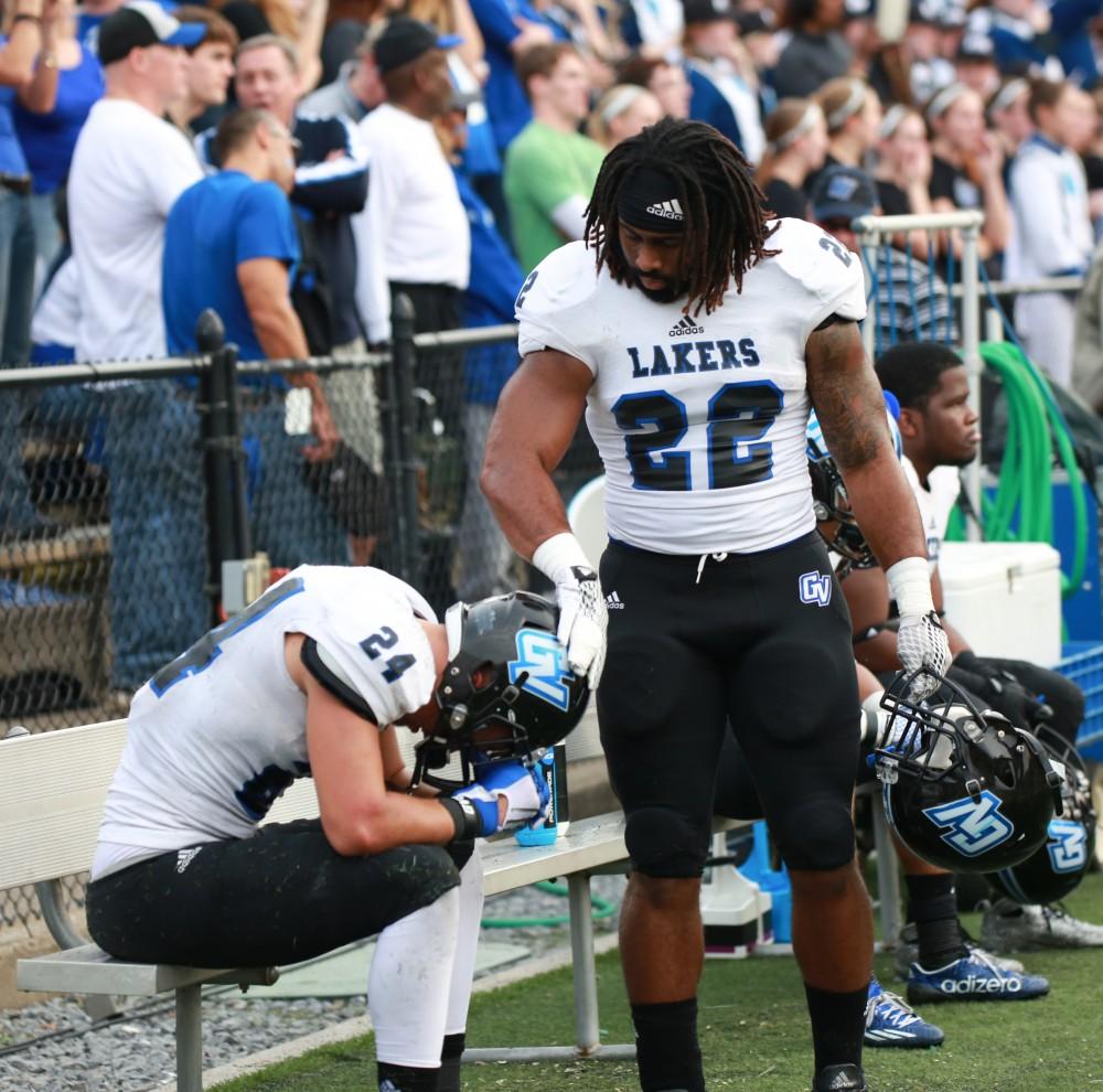 GVL / Kevin Sielaff - Terrell Dorsey (22) lifts the head of Matt Williams (24) as the game draws itself to a close.  The Lakers fall to the Rams of Shepard University with a final score of 34-32 Dec. 12 in Shepardstown, West Virginia.