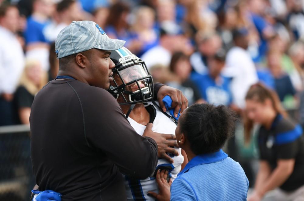 GVL / Kevin Sielaff - Former player Isiah Dunning comforts Justice Wright (13) on the sideline as the clock winds down.  The Lakers fall to the Rams of Shepard University with a final score of 34-32 Dec. 12 in Shepardstown, West Virginia.