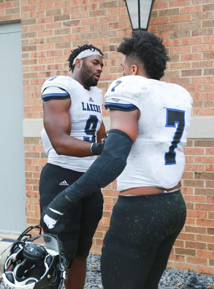 GVL / Kevin Sielaff -  Matt Judon (9) shakes hands with David Talley (7) after the match comes to a close.  The Lakers fall to the Rams of Shepard University with a final score of 34-32 Dec. 12 in Shepardstown, West Virginia.