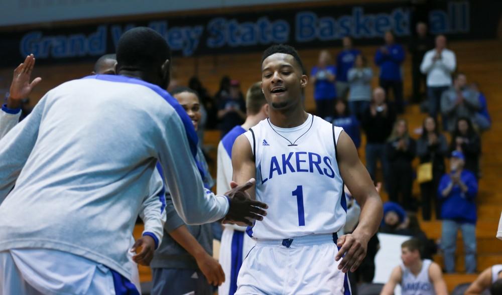 GVL / Kevin Sielaff - Aaron Hayes (1) is greeted by his teammates before the match.  The Lakers fall to the Eagles of Ashland University in a tough overtime loss Dec. 3 in Allendale. The final score was 76-72.