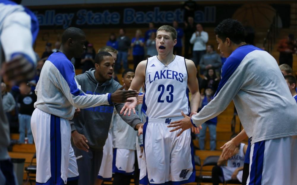 GVL / Kevin Sielaff - Luke Ryskamp (23) is greeted by his teammates before the match.  The Lakers fall to the Eagles of Ashland University in a tough overtime loss Dec. 3 in Allendale. The final score was 76-72.