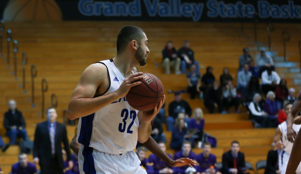 GVL / Kevin Sielaff - Ricardo Carbajal (32) holds the ball in the paint and looks for an outlet pass.  The Lakers fall to the Eagles of Ashland University in a tough overtime loss Dec. 3 in Allendale. The final score was 76-72.