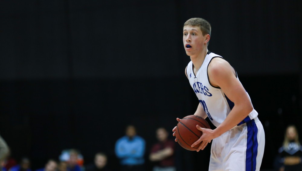 GVL / Kevin Sielaff - Luke Ryskamp (23) looks for a pass around the arc.  The Lakers fall to the Eagles of Ashland University in a tough overtime loss Dec. 3 in Allendale. The final score was 76-72.