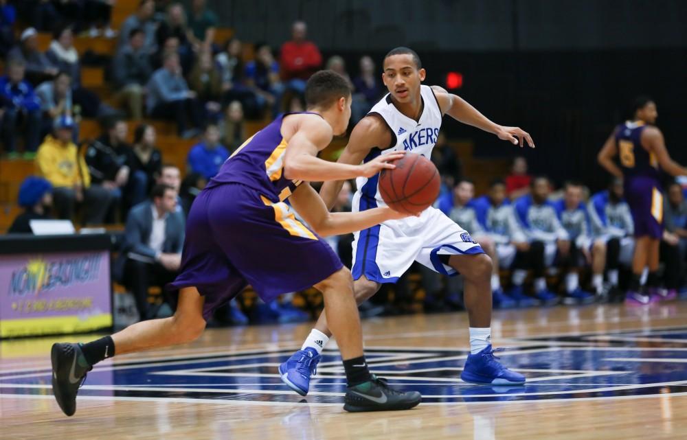 GVL / Kevin Sielaff - Myles Miller (12) defends an Ashland point guard.  The Lakers fall to the Eagles of Ashland University in a tough overtime loss Dec. 3 in Allendale. The final score was 76-72.