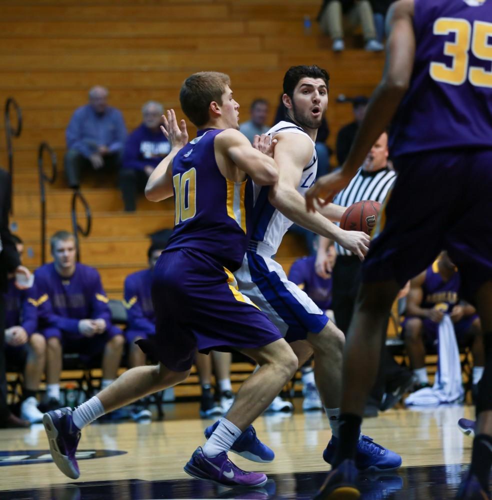 GVL / Kevin Sielaff - Zach West (11) looks for an outlet pass as he backs into the paint.  The Lakers fall to the Eagles of Ashland University in a tough overtime loss Dec. 3 in Allendale. The final score was 76-72.