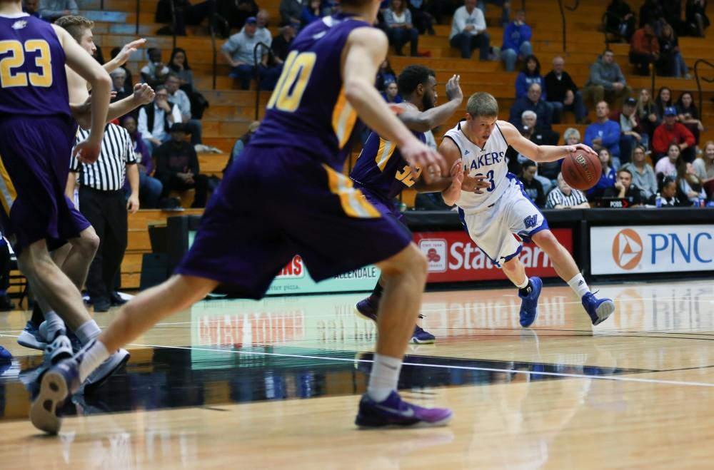 GVL / Kevin Sielaff - Luke Ryskamp (23) drives down the lane.  The Lakers fall to the Eagles of Ashland University in a tough overtime loss Dec. 3 in Allendale. The final score was 76-72.