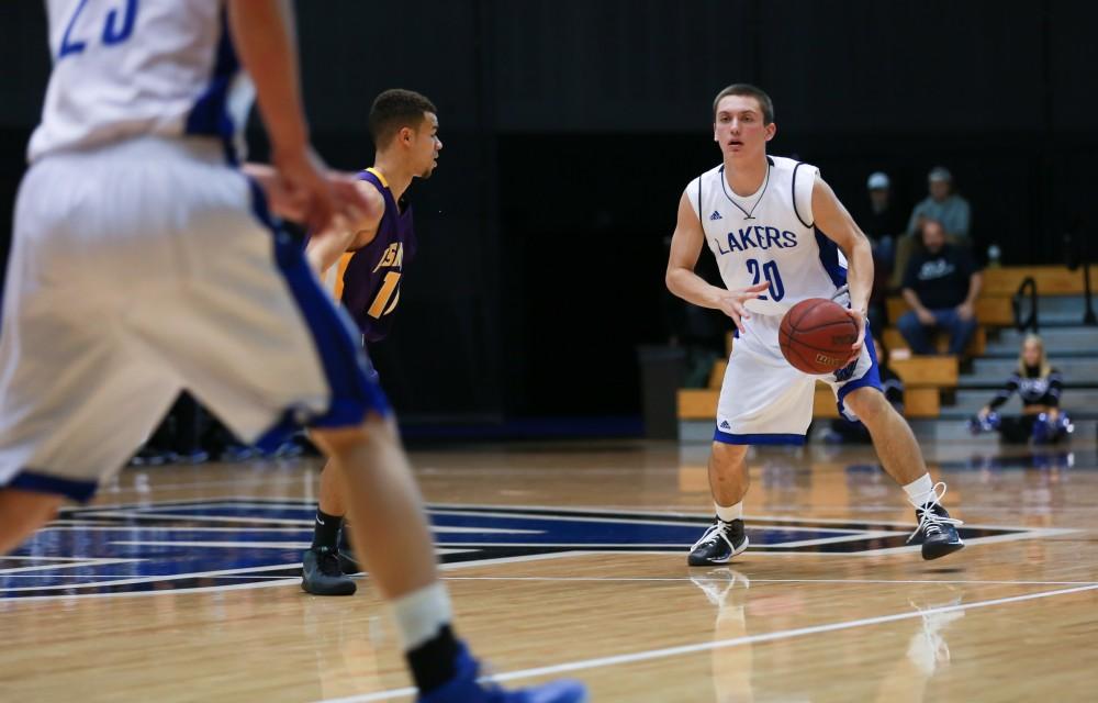 GVL / Kevin Sielaff - Alec Marty (20) passes the ball around the top of the arc.  The Lakers fall to the Eagles of Ashland University in a tough overtime loss Dec. 3 in Allendale. The final score was 76-72.