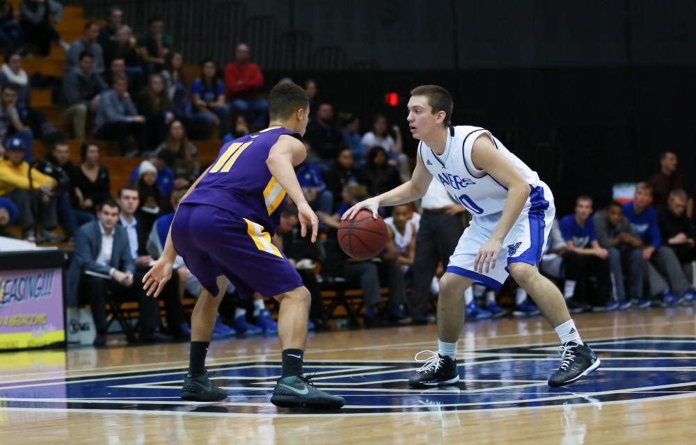 GVL / Kevin Sielaff - Alec Marty (20) dribbles the ball up the court.  The Lakers fall to the Eagles of Ashland University in a tough overtime loss Dec. 3 in Allendale. The final score was 76-72.