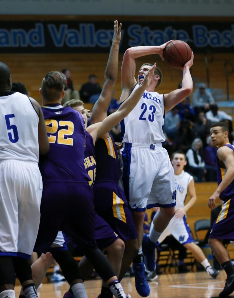 GVL / Kevin Sielaff - Luke Ryskamp (23) drives the ball hard on net.  The Lakers fall to the Eagles of Ashland University in a tough overtime loss Dec. 3 in Allendale. The final score was 76-72.