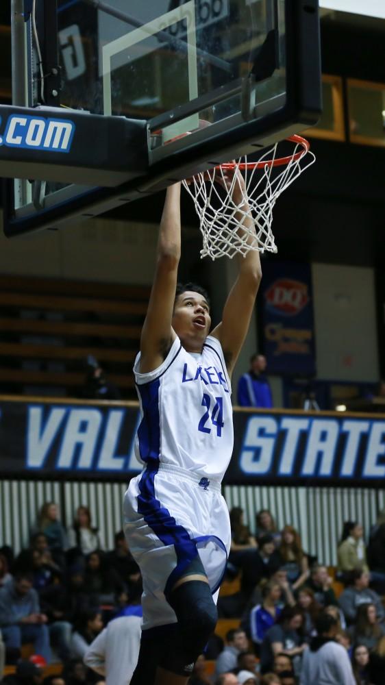 GVL / Kevin Sielaff - In warm up, Justin Greason (24) dunks the ball.  The Lakers fall to the Eagles of Ashland University in a tough overtime loss Dec. 3 in Allendale. The final score was 76-72.