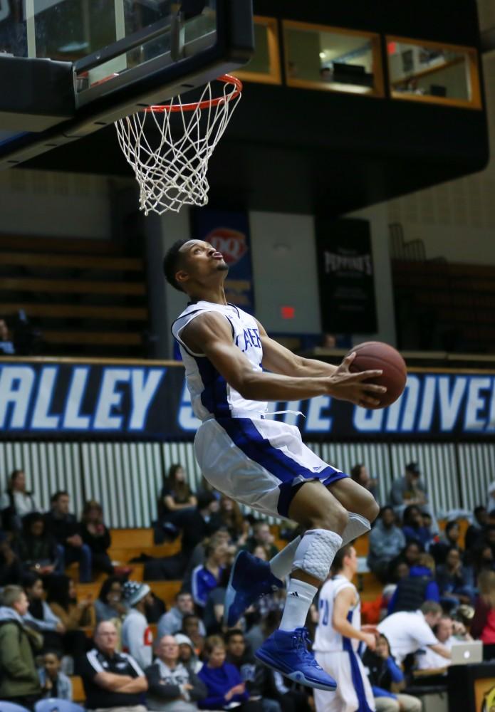 GVL / Kevin Sielaff - In warm up, Aaron Hayes (1) dunks the ball.  The Lakers fall to the Eagles of Ashland University in a tough overtime loss Dec. 3 in Allendale. The final score was 76-72.