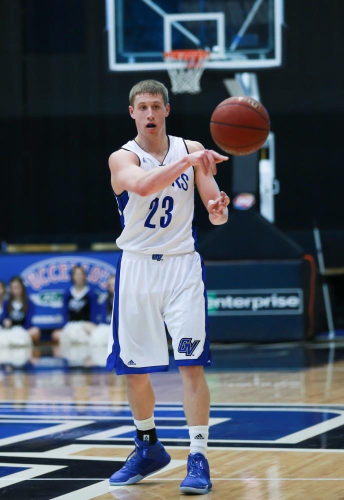 GVL / Kevin Sielaff - Luke Ryskamp (23) passes the ball around the arc.  The Lakers fall to the Eagles of Ashland University in a tough overtime loss Dec. 3 in Allendale. The final score was 76-72.