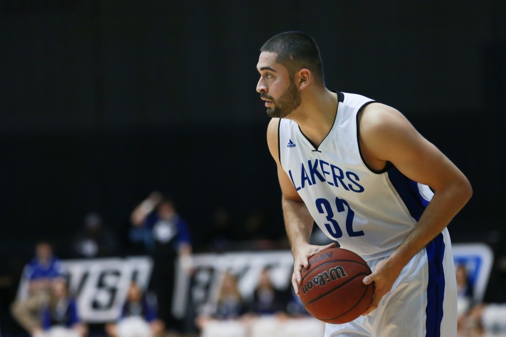 GVL / Kevin Sielaff - Ricardo Carbajal (32) looks for a pass.  The Lakers fall to the Eagles of Ashland University in a tough overtime loss Dec. 3 in Allendale. The final score was 76-72.