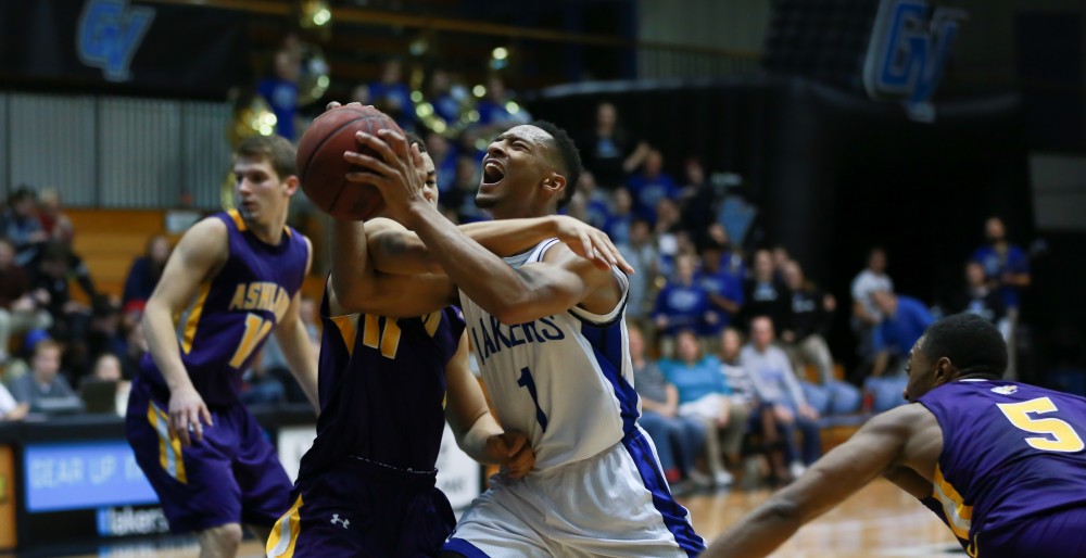 GVL / Kevin Sielaff - Aaron Hayes (1) is hacked as he powers to the rim.  The Lakers fall to the Eagles of Ashland University in a tough overtime loss Dec. 3 in Allendale. The final score was 76-72.