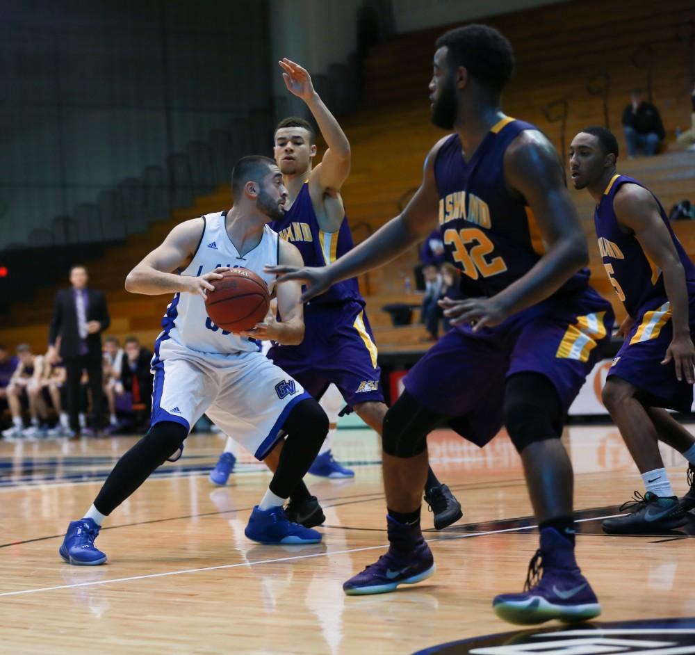 GVL / Kevin Sielaff - Ricardo Carbajal (32) is met by a hoard of Ashland defenders.  The Lakers fall to the Eagles of Ashland University in a tough overtime loss Dec. 3 in Allendale. The final score was 76-72.