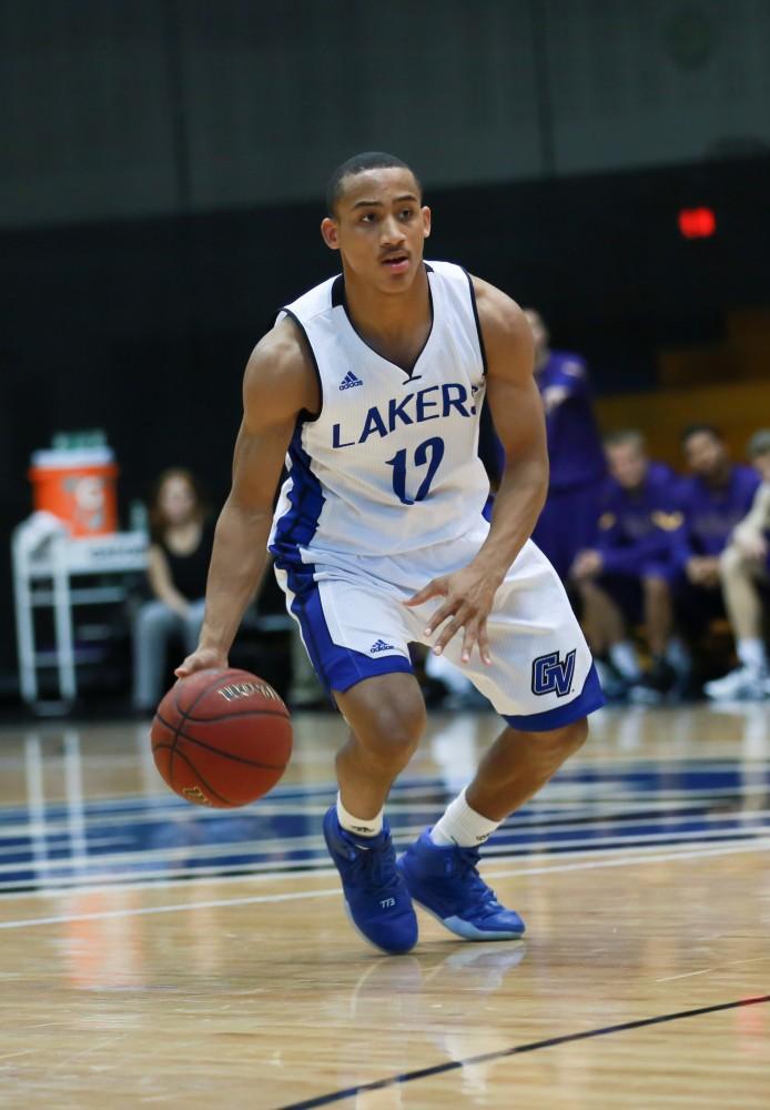 GVL / Kevin Sielaff - Mylers Miller (12) looks for a pass down the lane.  The Lakers fall to the Eagles of Ashland University in a tough overtime loss Dec. 3 in Allendale. The final score was 76-72.