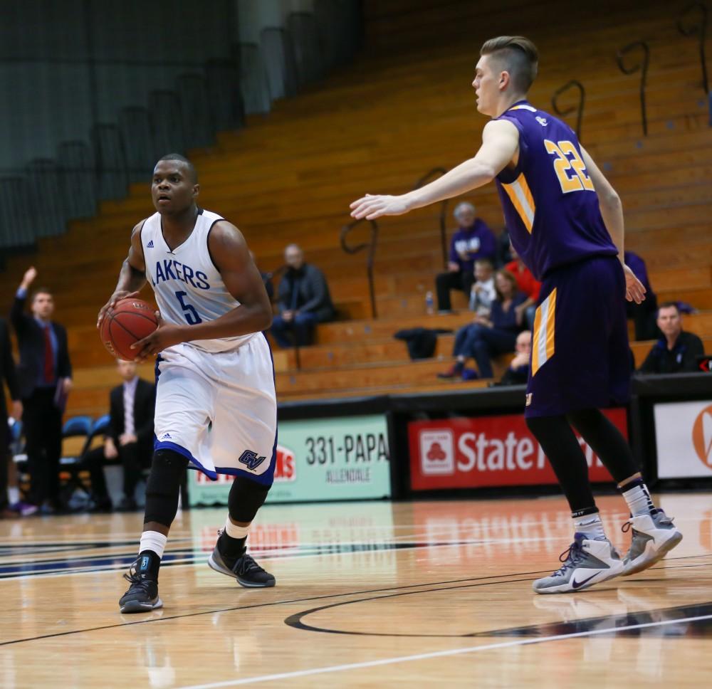 GVL / Kevin Sielaff - Trevin Alexander (5) looks for a pass at the top of the arc.  The Lakers fall to the Eagles of Ashland University in a tough overtime loss Dec. 3 in Allendale. The final score was 76-72.