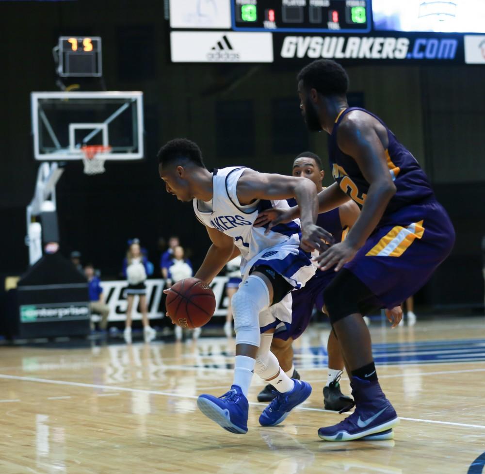 GVL / Kevin Sielaff - Aaron Hayes (1) tries to get a shot up as the clock winds down, but is pressured by Ashland.  The Lakers fall to the Eagles of Ashland University in a tough overtime loss Dec. 3 in Allendale. The final score was 76-72.