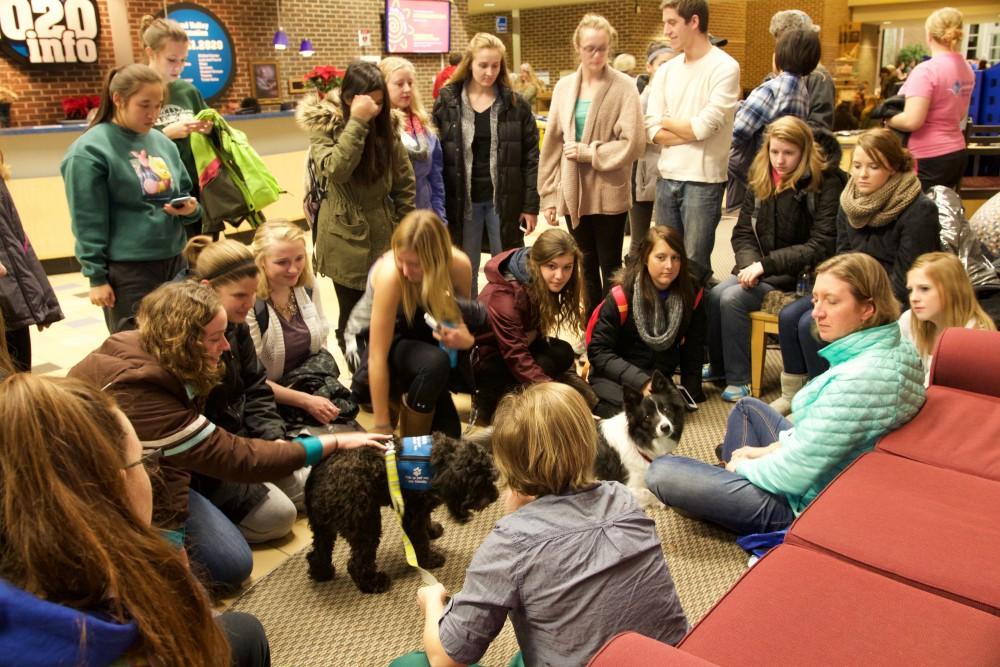 GVL / Sara CarteGrand Valley students play with therapy puppies to relieve stress from finals week in the Kirkhof building on Dec. 7.