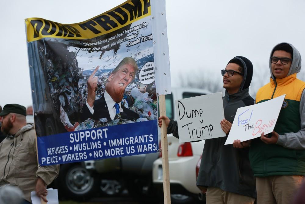 GVL / Kevin Sielaff - Protestors gather near the entrance of the venue to voice their opinions about Donald Trump.  Republican front runner Donald Trump packs the Deltaplex Arena and Conference Center in downtown Grand Rapids Dec. 21 for a presidential rally. The event boasted the largest crowd ever held at the Deltaplex arena.