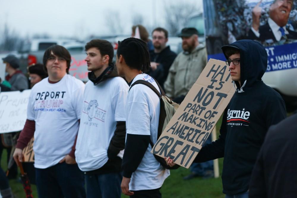 GVL / Kevin Sielaff - Protestors gather near the entrance of the venue to voice their opinions about Donald Trump.  Republican front runner Donald Trump packs the Deltaplex Arena and Conference Center in downtown Grand Rapids Dec. 21 for a presidential rally. The event boasted the largest crowd ever held at the Deltaplex arena.