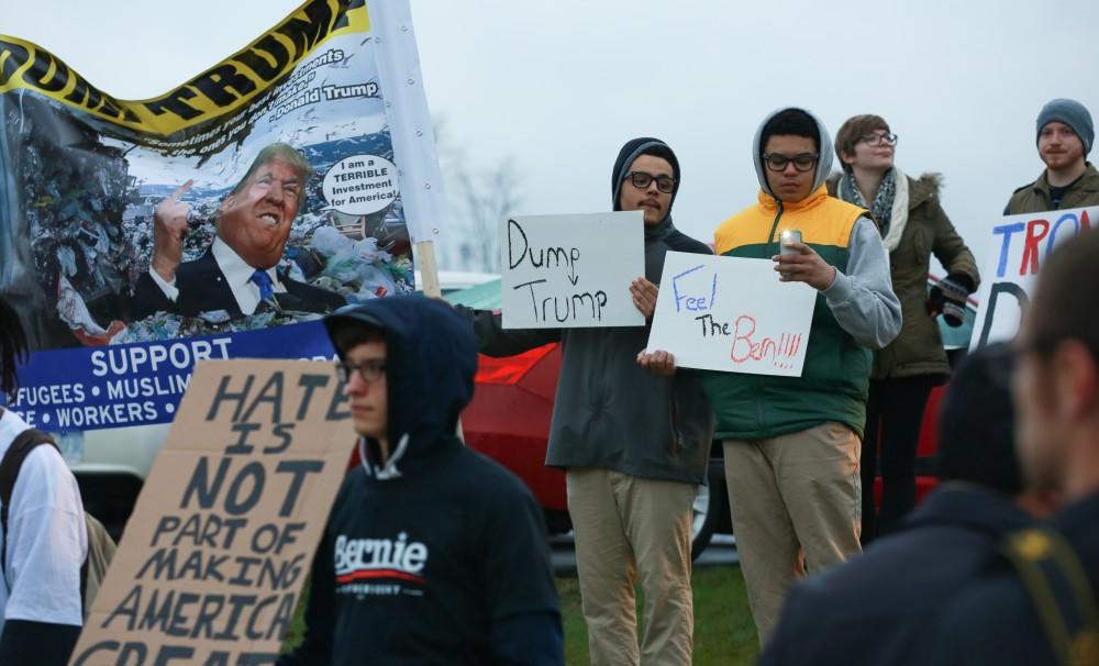 GVL / Kevin Sielaff - Protestors gather near the entrance of the venue to voice their opinions about Donald Trump.  Republican front runner Donald Trump packs the Deltaplex Arena and Conference Center in downtown Grand Rapids Dec. 21 for a presidential rally. The event boasted the largest crowd ever held at the Deltaplex arena.