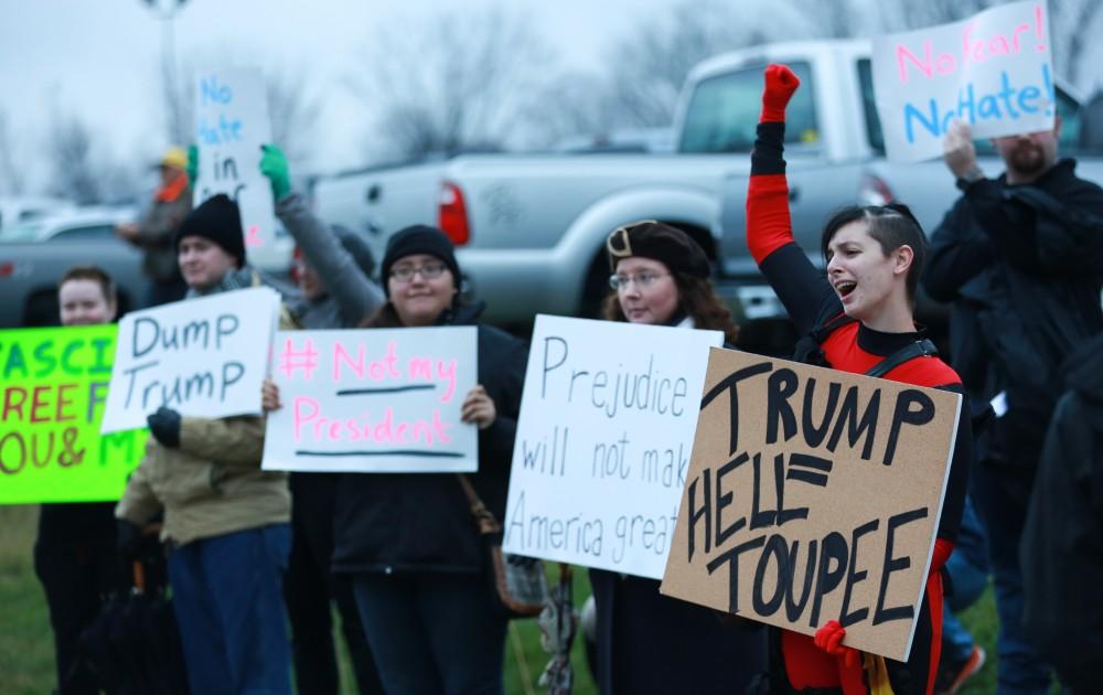 GVL / Kevin Sielaff - Protestors gather near the entrance of the venue to voice their opinions about Donald Trump.  Republican front runner Donald Trump packs the Deltaplex Arena and Conference Center in downtown Grand Rapids Dec. 21 for a presidential rally. The event boasted the largest crowd ever held at the Deltaplex arena.