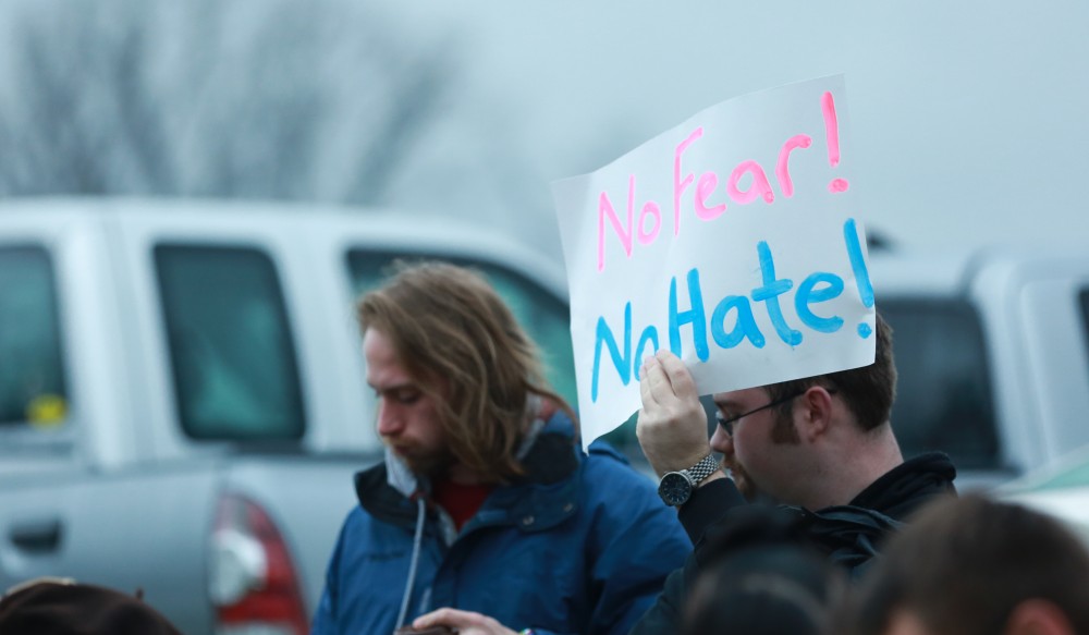 GVL / Kevin Sielaff - Protestors gather near the entrance of the venue to voice their opinions about Donald Trump.  Republican front runner Donald Trump packs the Deltaplex Arena and Conference Center in downtown Grand Rapids Dec. 21 for a presidential rally. The event boasted the largest crowd ever held at the Deltaplex arena.