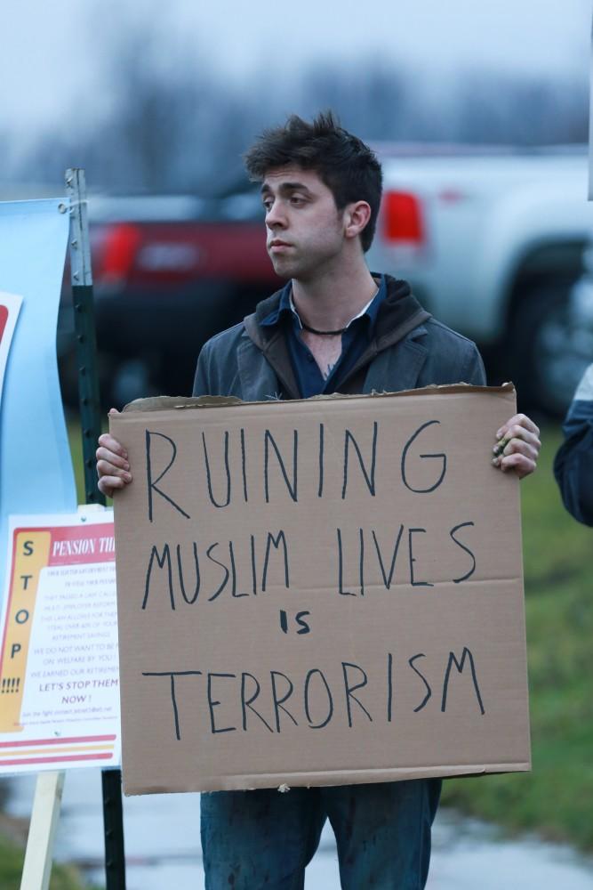 GVL / Kevin Sielaff - Protestors gather near the entrance of the venue to voice their opinions about Donald Trump.  Republican front runner Donald Trump packs the Deltaplex Arena and Conference Center in downtown Grand Rapids Dec. 21 for a presidential rally. The event boasted the largest crowd ever held at the Deltaplex arena.