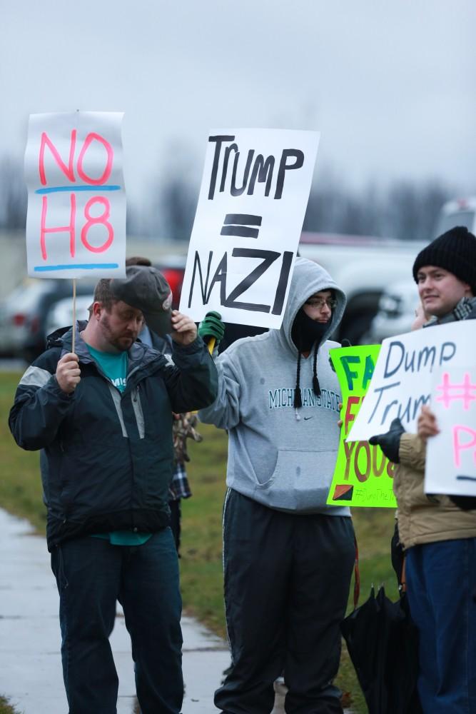 GVL / Kevin Sielaff - Protestors gather near the entrance of the venue to voice their opinions about Donald Trump.  Republican front runner Donald Trump packs the Deltaplex Arena and Conference Center in downtown Grand Rapids Dec. 21 for a presidential rally. The event boasted the largest crowd ever held at the Deltaplex arena.