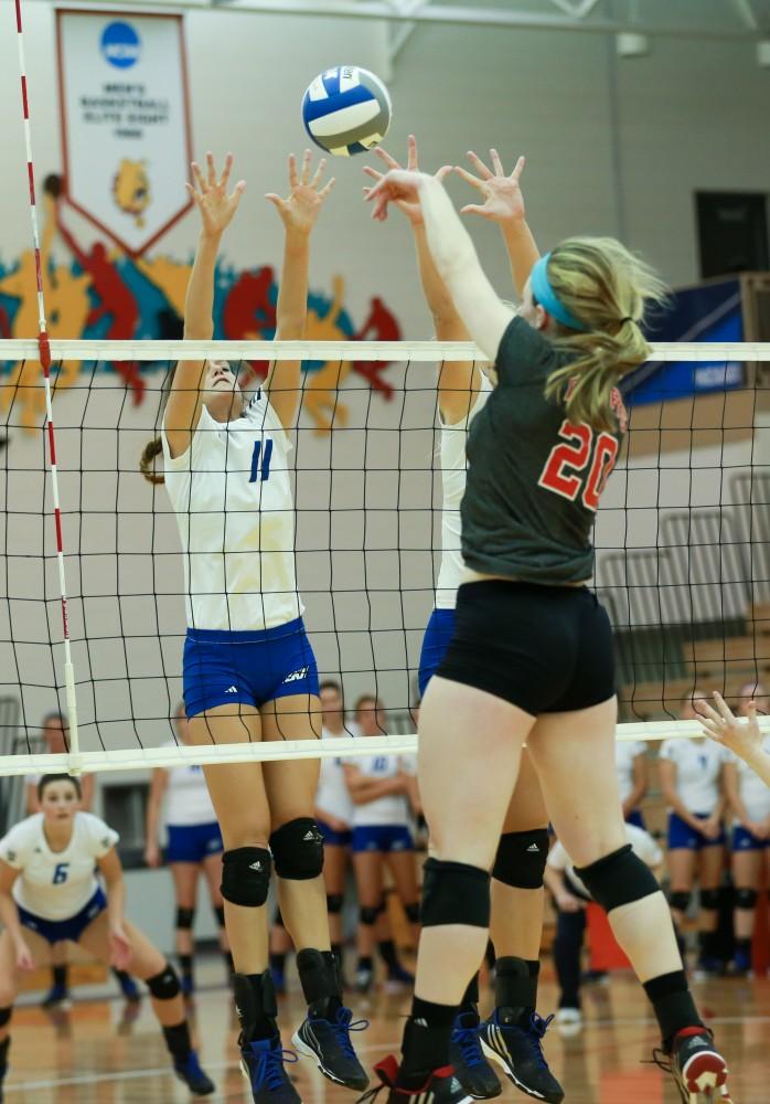 GVL / Kevin Sielaff - Kourtney Wolters (11) meets Maddie Seliga (20) of Lewis at the net.  The Lakers fall to the Flyers of Lewis University Dec. 3 in Big Rapids, MI in the first round of the NCAA midwest regional tournament by a margin of 3-1.