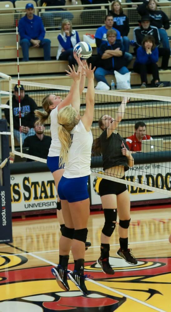 GVL / Kevin Sielaff - Staci Brower (21) elevates to get a hand on the ball.  The Lakers fall to the Flyers of Lewis University Dec. 3 in Big Rapids, MI in the first round of the NCAA midwest regional tournament by a margin of 3-1.