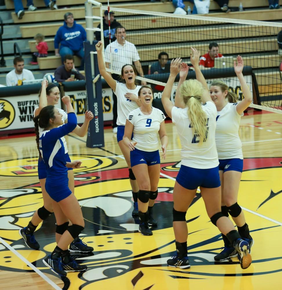 GVL / Kevin Sielaff - Katie Olson (9) and the Lakers celebrate a point scored.  The Lakers fall to the Flyers of Lewis University Dec. 3 in Big Rapids, MI in the first round of the NCAA midwest regional tournament by a margin of 3-1.