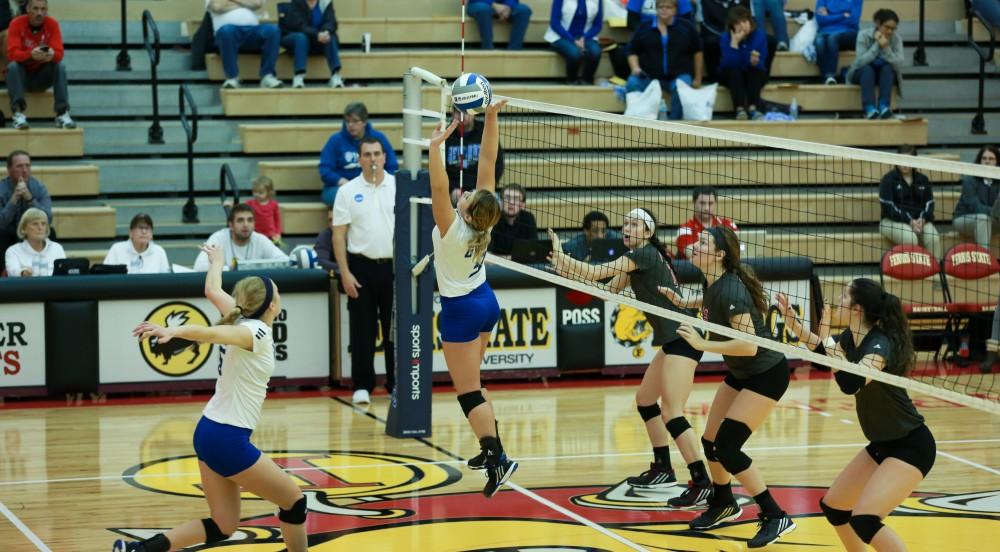 GVL / Kevin Sielaff - Katie Olson (9) serves the ball for Kaleigh Lound (15).  The Lakers fall to the Flyers of Lewis University Dec. 3 in Big Rapids, MI in the first round of the NCAA midwest regional tournament by a margin of 3-1.