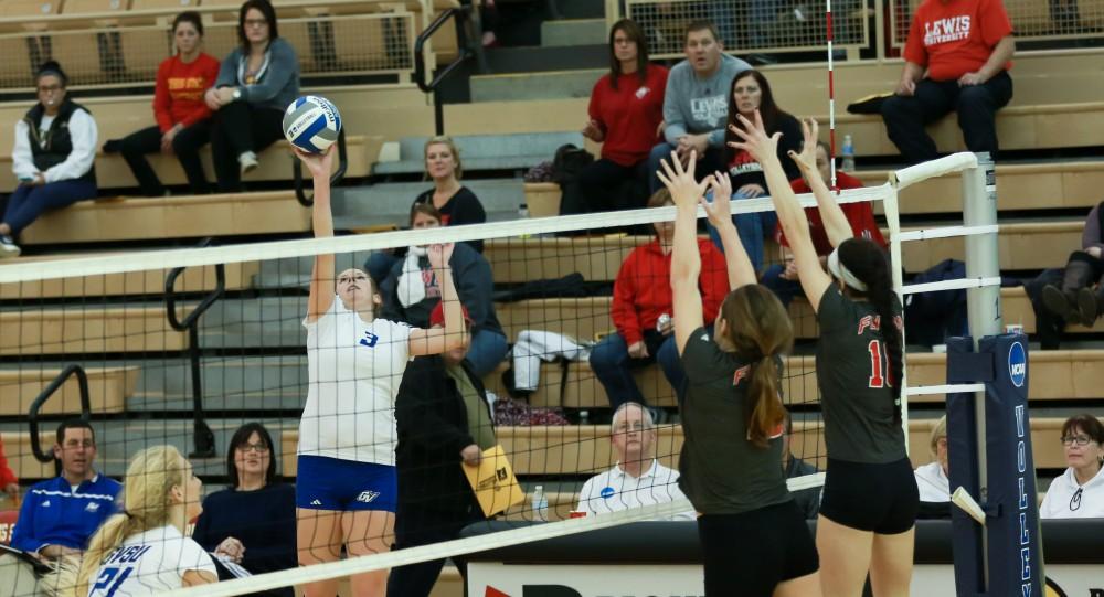 GVL / Kevin Sielaff - Jessica Majerle (3) gets a hand on the ball and tips it over the hands of Lewis.  The Lakers fall to the Flyers of Lewis University Dec. 3 in Big Rapids, MI in the first round of the NCAA midwest regional tournament by a margin of 3-1.