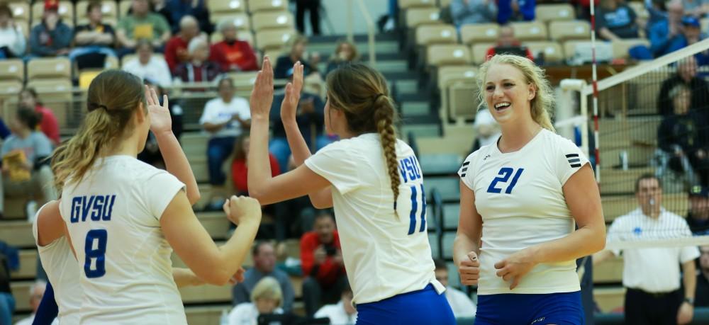 GVL / Kevin Sielaff - Staci Brower (21) celebrates with her teammates.  The Lakers fall to the Flyers of Lewis University Dec. 3 in Big Rapids, MI in the first round of the NCAA midwest regional tournament by a margin of 3-1.