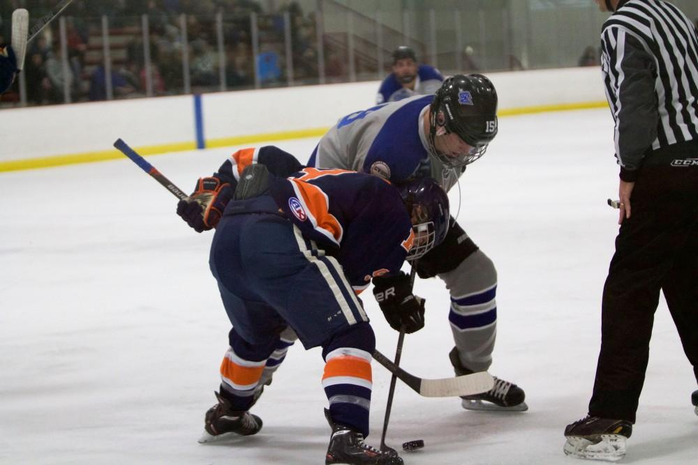 GVL / Sara Carte
Grand Valley Men’s Ice Hockey D3 player, Nick Pratt, fights for the puck against Hope College at the Georgetown Ice Arena on Jan 16. 