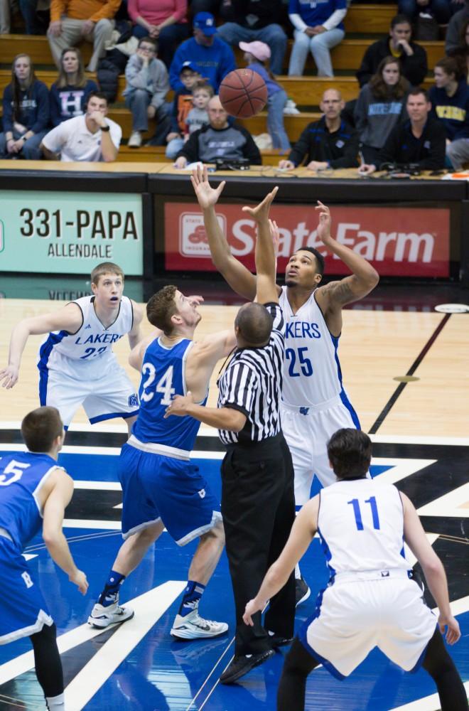 GVL / Kevin Sielaff - Chaz Rollins (25) takes the first jump ball of the match.  The Lakers defeat the Chargers of Hillsdale College Saturday, Jan. 30, 2016 in Allendale.