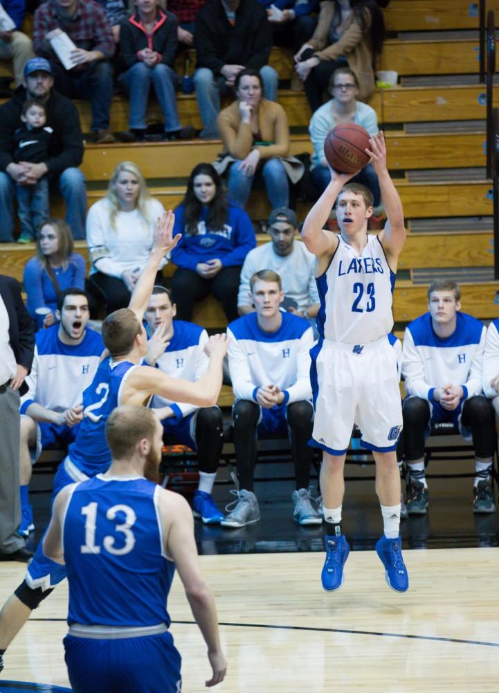 GVL / Kevin Sielaff - Luke Ryskamp (23) tries a three point shot.  The Lakers defeat the Chargers of Hillsdale College Saturday, Jan. 30, 2016 in Allendale.