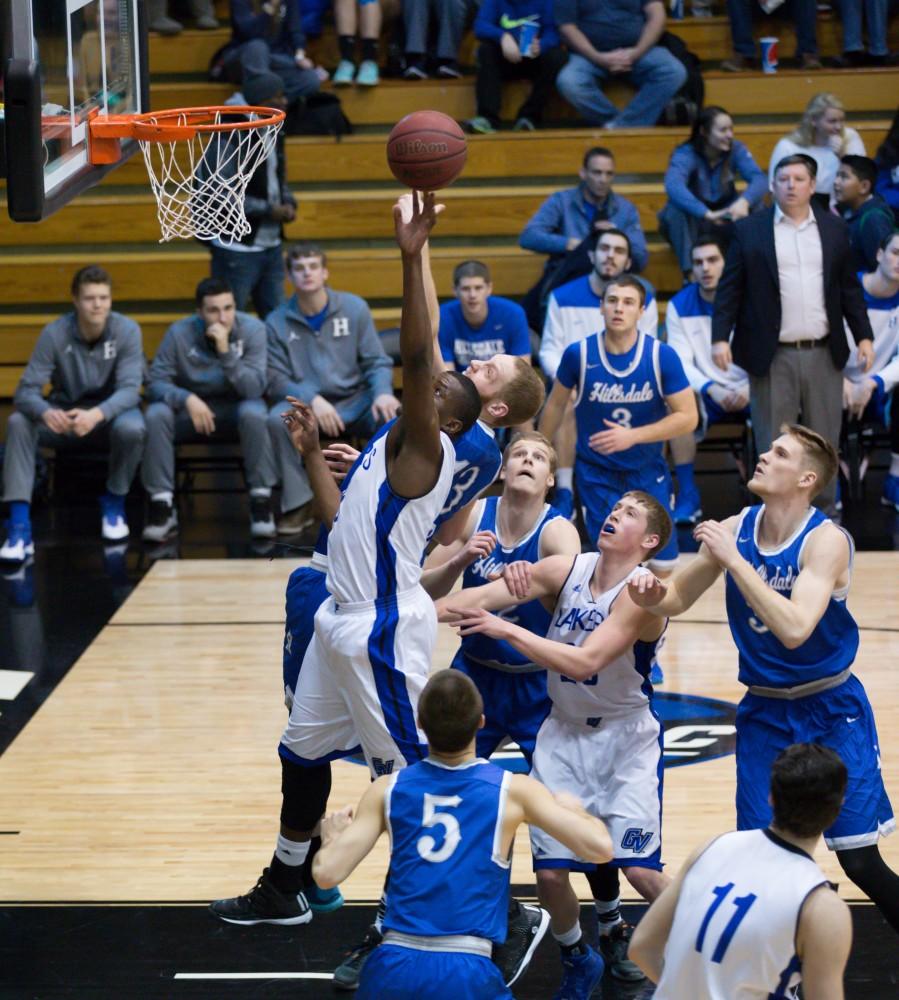 GVL / Kevin Sielaff - Trevin Alexander (5) reaches for an offensive rebound.  The Lakers defeat the Chargers of Hillsdale College Saturday, Jan. 30, 2016 in Allendale.