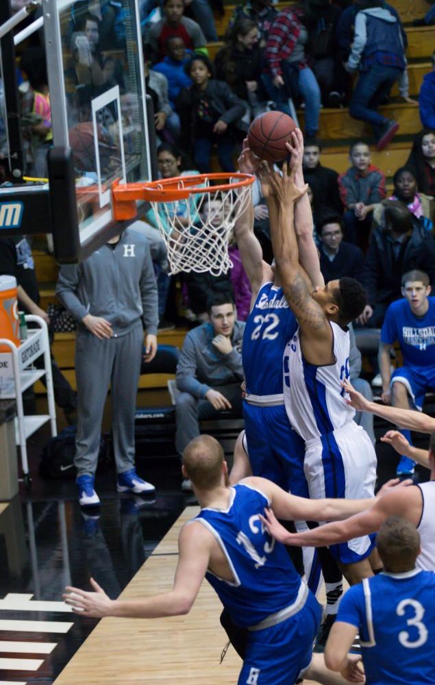 GVL / Kevin Sielaff - Chaz Rollins (25) reaches for an offensive rebound.  The Lakers defeat the Chargers of Hillsdale College Saturday, Jan. 30, 2016 in Allendale.