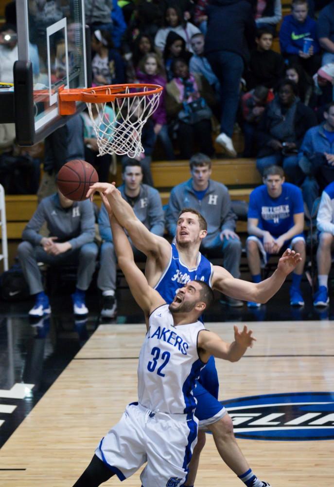 GVL / Kevin Sielaff - Ricardo Carbajal (32) is denied at the rim by Hillsdale's Kyle Cooper (24).  The Lakers defeat the Chargers of Hillsdale College Saturday, Jan. 30, 2016 in Allendale.