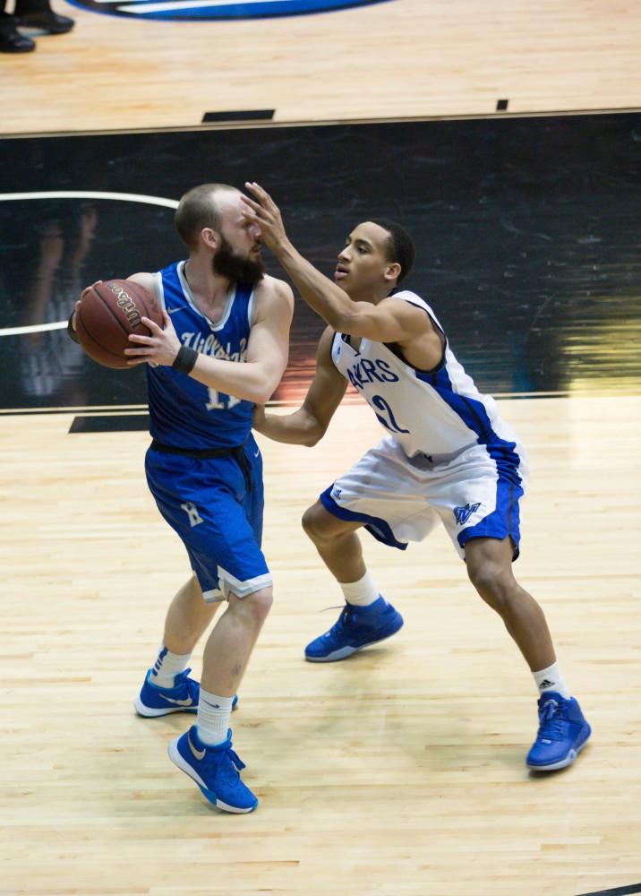 GVL / Kevin Sielaff - Myles Miller (12) blocks the view of Hillsdale's Zach Miller (11).  The Lakers defeat the Chargers of Hillsdale College Saturday, Jan. 30, 2016 in Allendale.